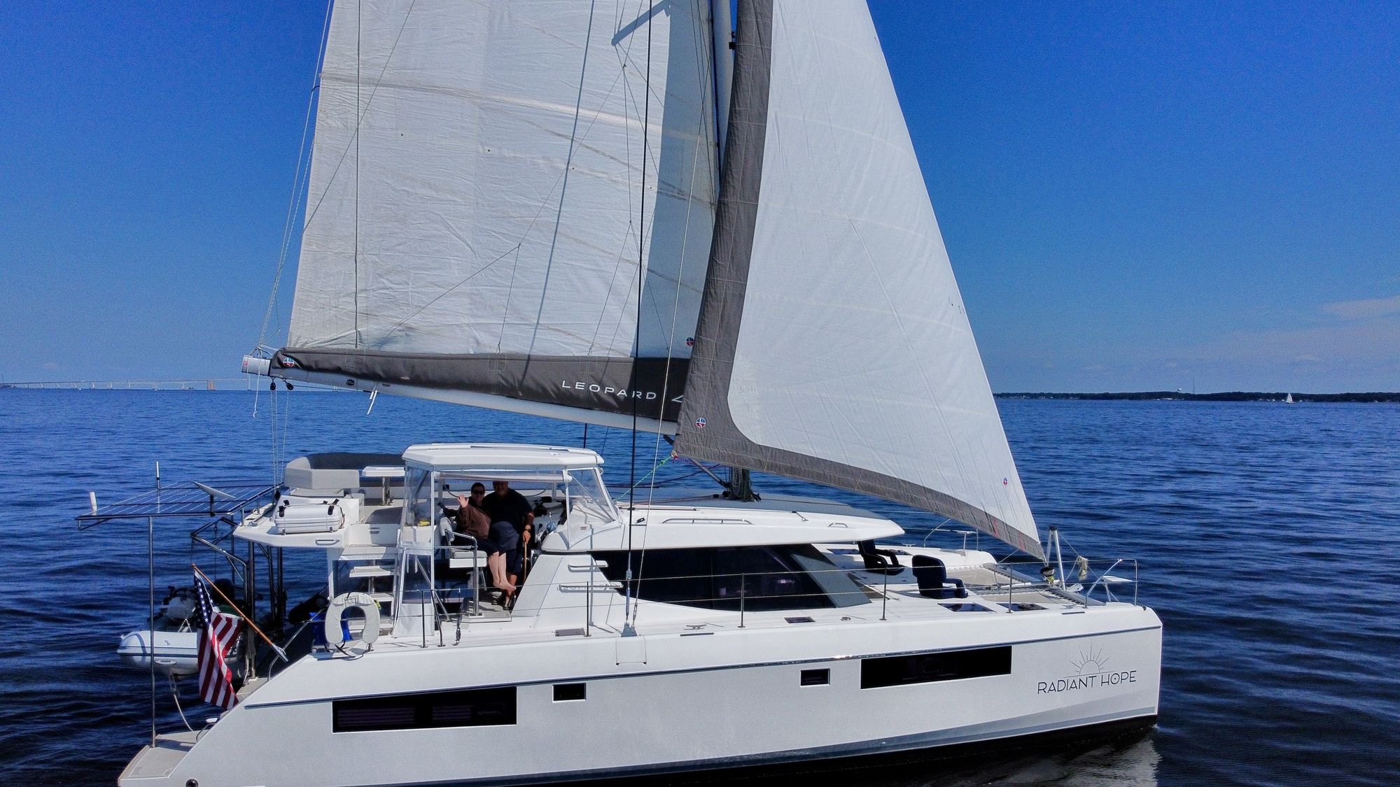 Radiant Hope under sail near the Chesapeake Bay Bridge, starboard beam, sails up